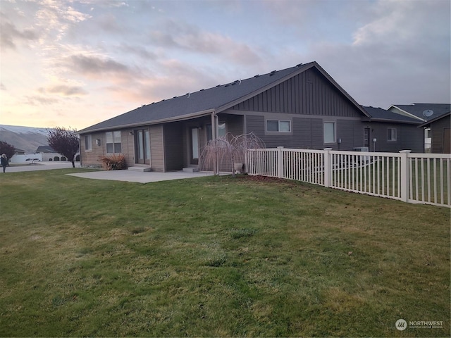 view of front of home featuring a patio area and a yard