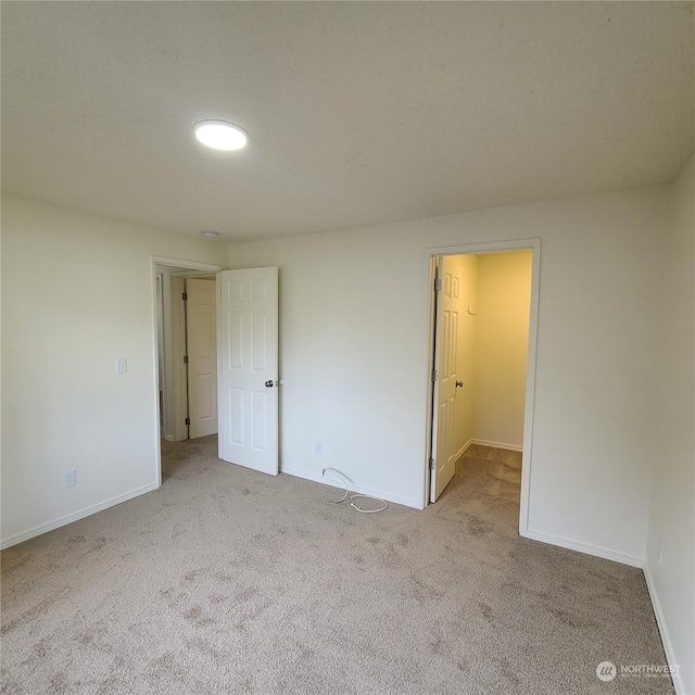 unfurnished room with light colored carpet