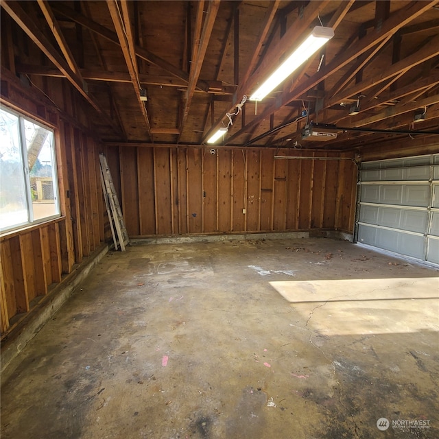 garage featuring wood walls and a garage door opener