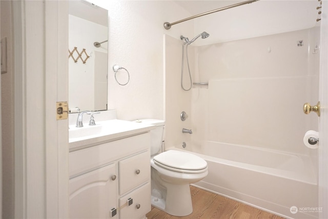 full bathroom with shower / bath combination, vanity, wood-type flooring, and toilet