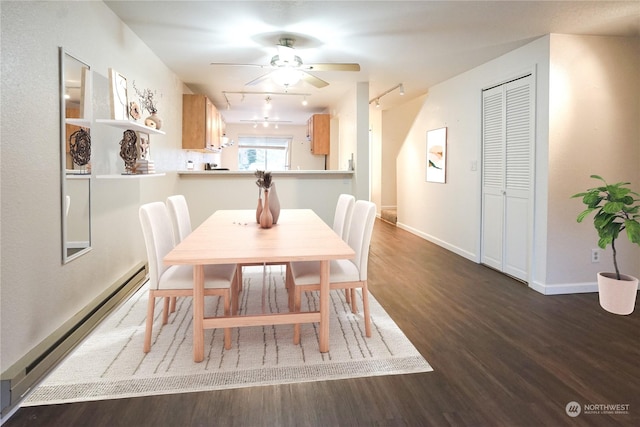 dining area featuring ceiling fan, dark hardwood / wood-style flooring, rail lighting, and a baseboard heating unit