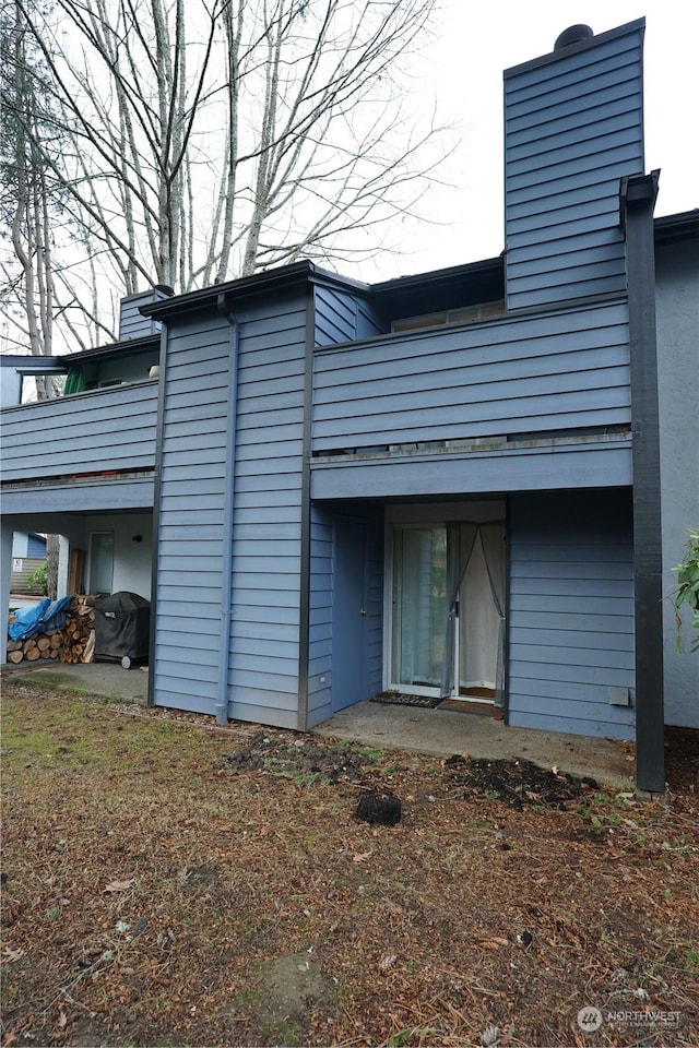 rear view of property with a balcony