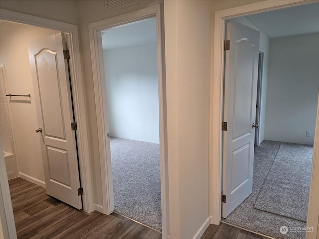 25 Newton Rd, Forks, WA 98331 - hallway with dark wood-style flooring and dark colored carpet