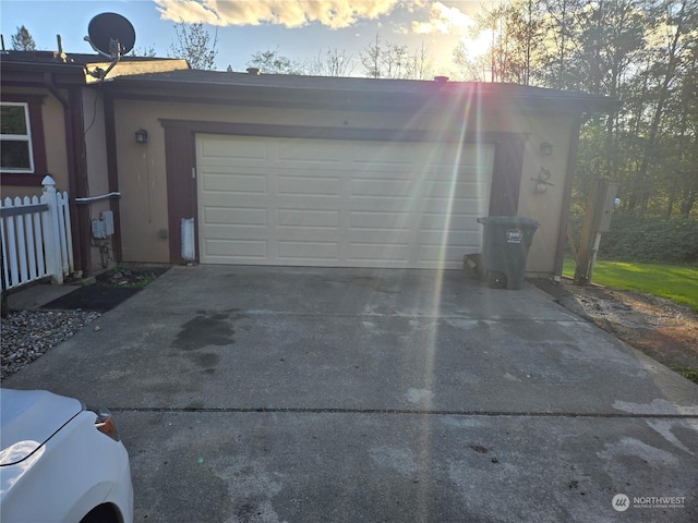 view of garage at dusk