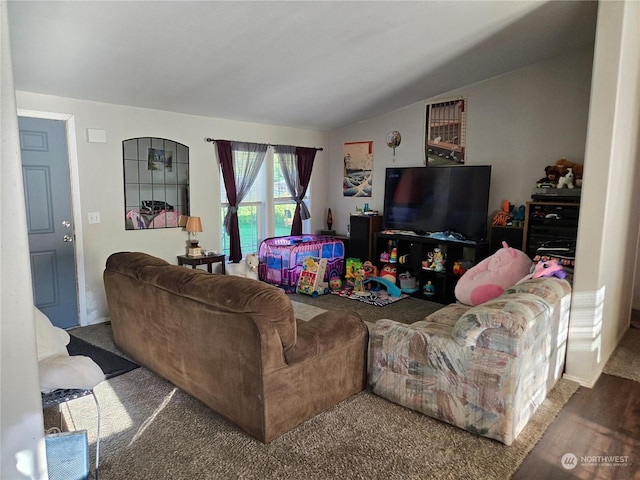 carpeted living room with lofted ceiling