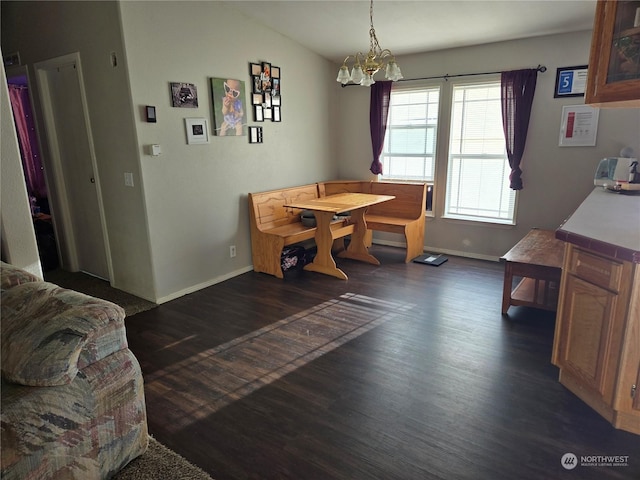 dining room featuring vaulted ceiling, dark hardwood / wood-style flooring, and an inviting chandelier