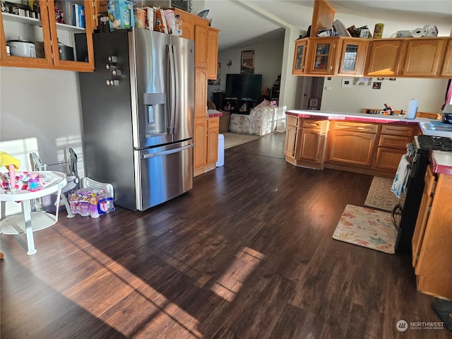 kitchen with lofted ceiling, dark hardwood / wood-style flooring, black electric range, and stainless steel refrigerator with ice dispenser