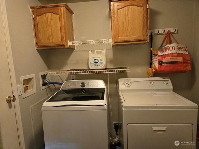 laundry room with washer and dryer and cabinets