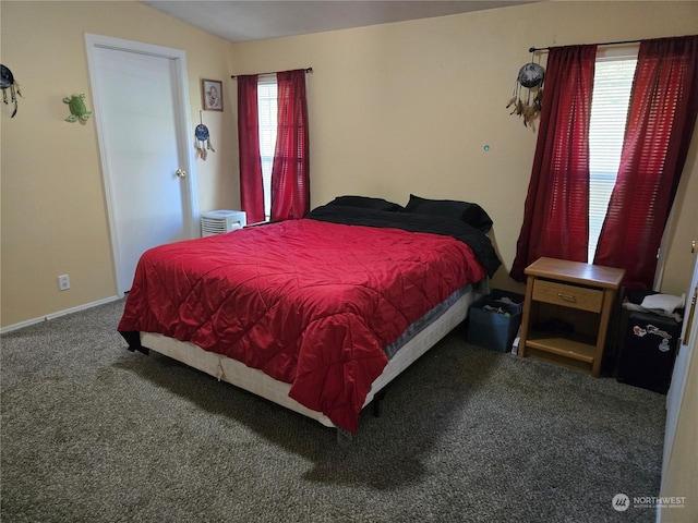 bedroom with carpet floors and vaulted ceiling