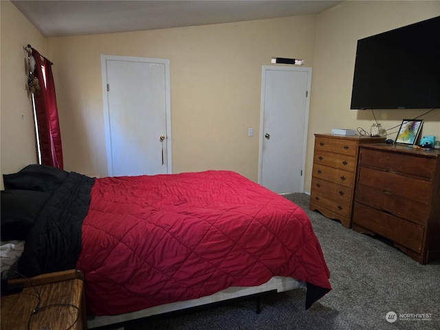 bedroom with carpet floors and vaulted ceiling