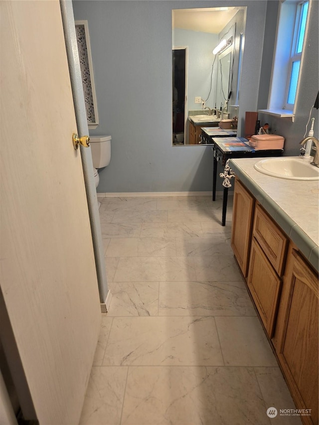 bathroom featuring vanity and toilet