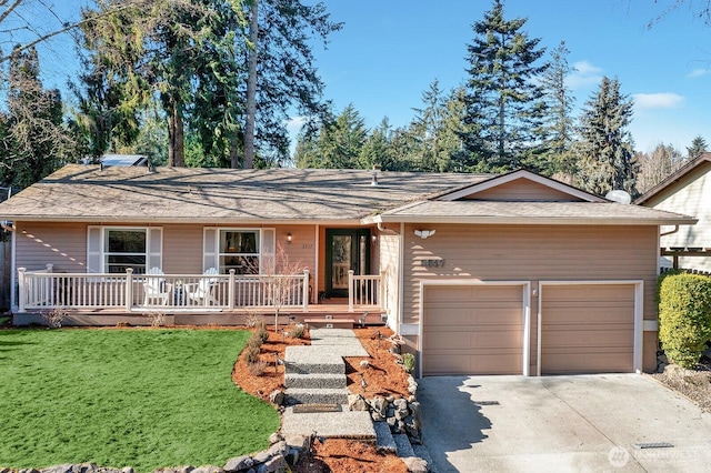 single story home featuring a porch, a garage, and a front yard