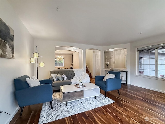 living room featuring a notable chandelier and wood-type flooring