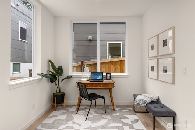 office featuring baseboards, plenty of natural light, and wood finished floors