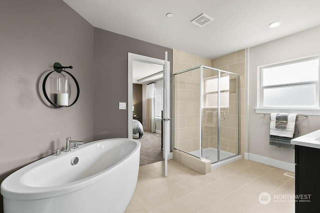 bathroom featuring tile patterned flooring, vanity, and shower with separate bathtub