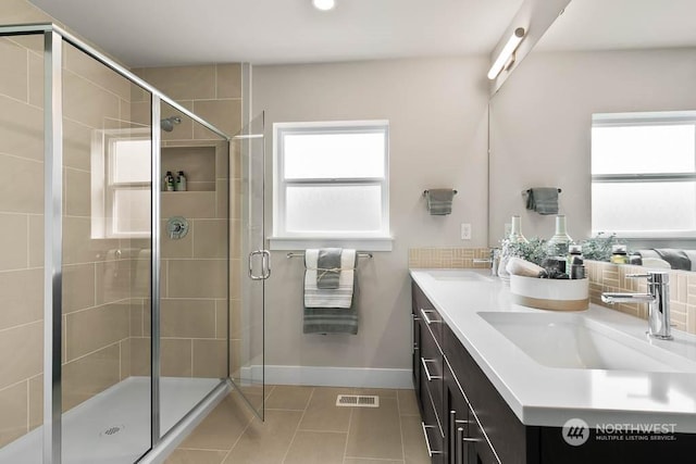 bathroom featuring tile patterned flooring, vanity, and a shower with door