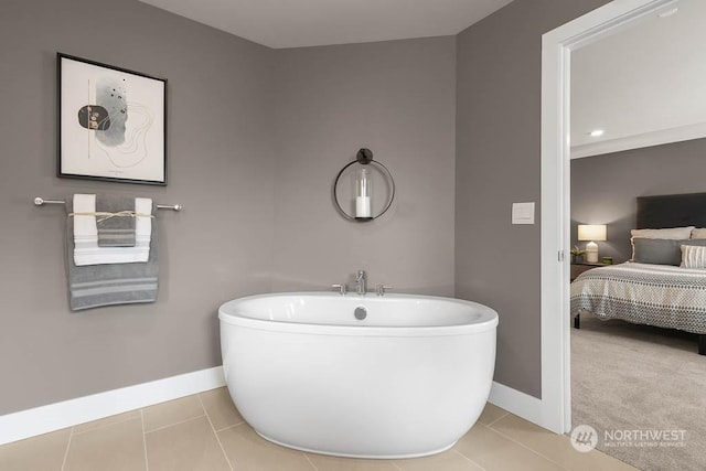 bathroom featuring tile patterned floors and a tub to relax in