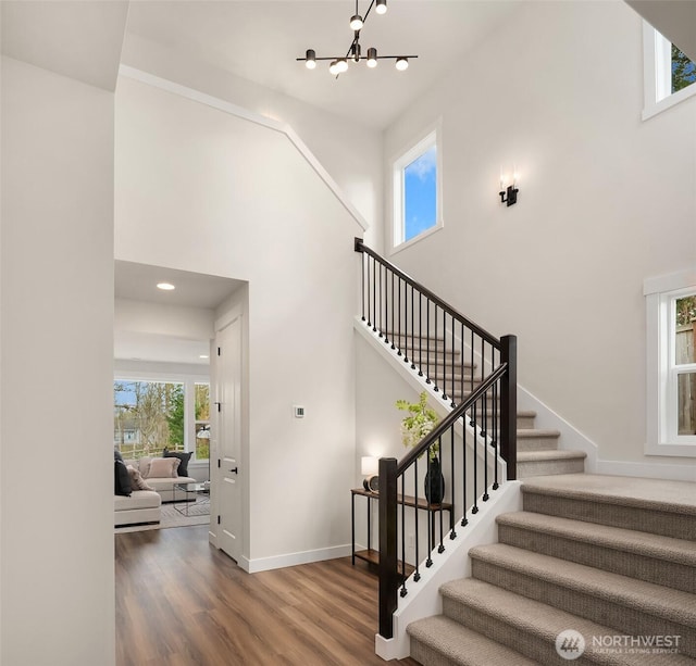 21416 116th Ave SE Unit 5, Kent, WA 98031 - stairs with wood finished floors, a chandelier, a towering ceiling, and recessed lighting