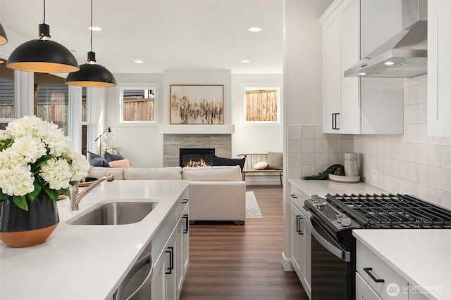 21416 116th Ave SE Unit 5, Kent, WA 98031 - kitchen featuring wall chimney range hood, gas stove, dishwasher, a glass covered fireplace, and dark wood finished floors