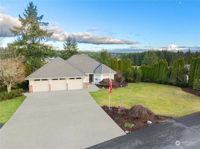 view of front of home with a garage and a front lawn