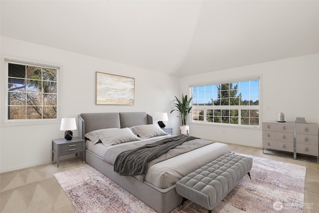 carpeted bedroom with vaulted ceiling