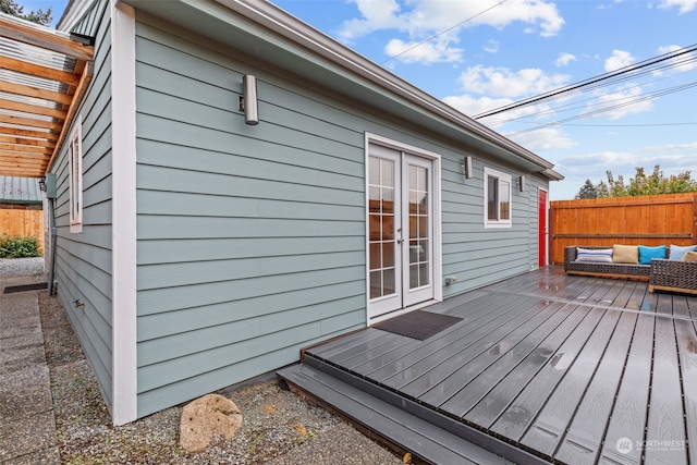 wooden deck with french doors and an outdoor hangout area