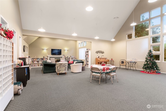 rec room with carpet flooring and high vaulted ceiling