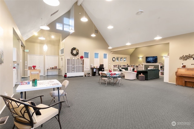 interior space featuring carpet flooring, high vaulted ceiling, and beamed ceiling