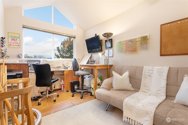 office with vaulted ceiling and light hardwood / wood-style flooring