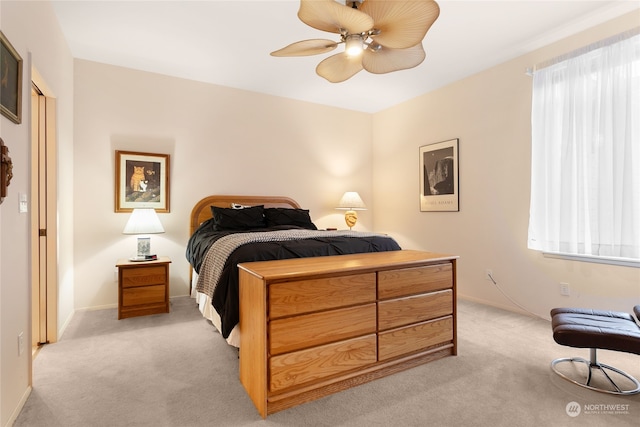 bedroom featuring light carpet and ceiling fan