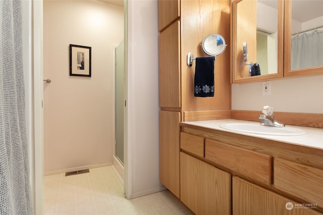 bathroom with curtained shower and vanity