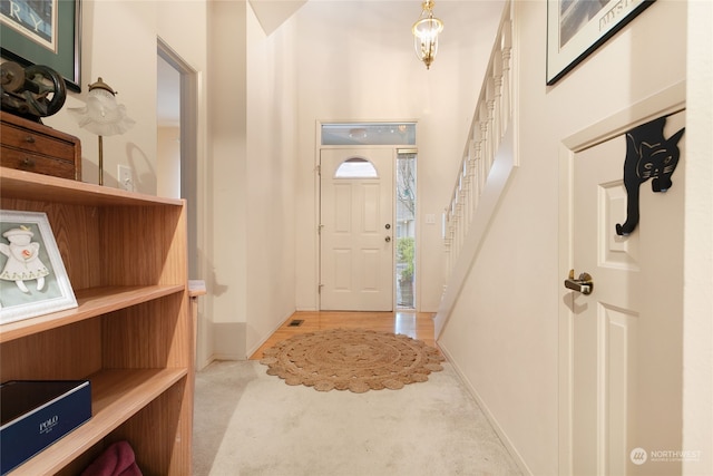 entrance foyer featuring light colored carpet