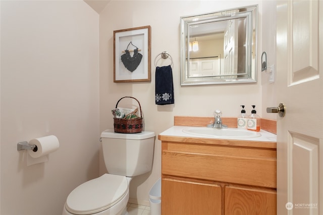 bathroom with tile patterned flooring, vanity, and toilet