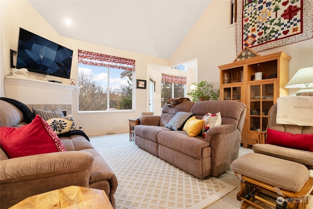 living room with light carpet and high vaulted ceiling