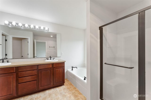 bathroom featuring plus walk in shower and vanity