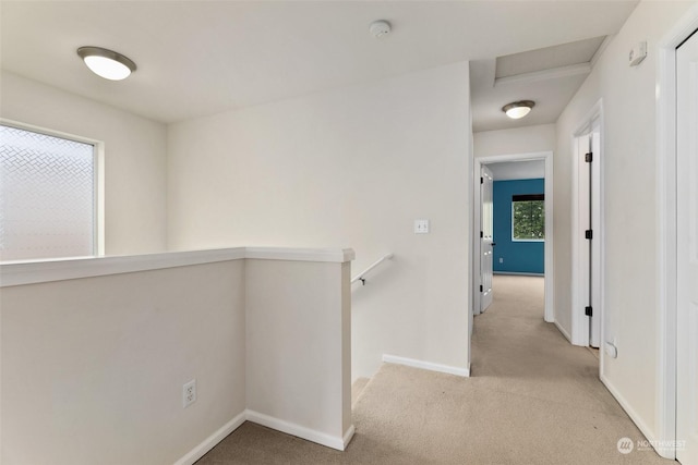 hallway with light colored carpet