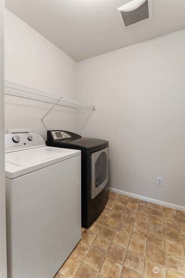 washroom with washing machine and dryer