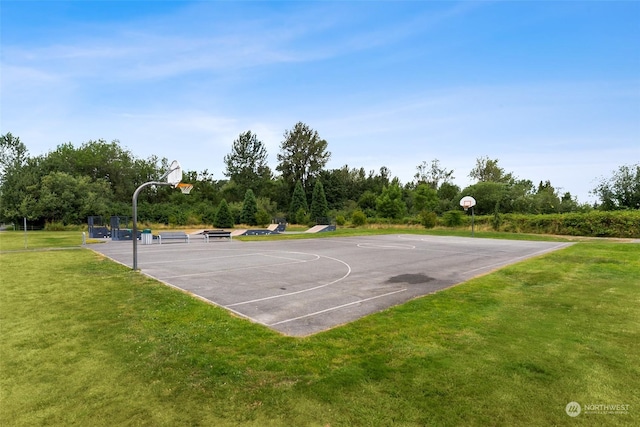 view of basketball court with a lawn