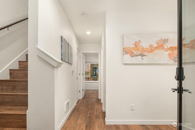 corridor with hardwood / wood-style floors