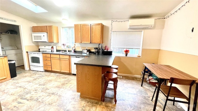 kitchen with plenty of natural light, white appliances, a breakfast bar, and a wall mounted AC