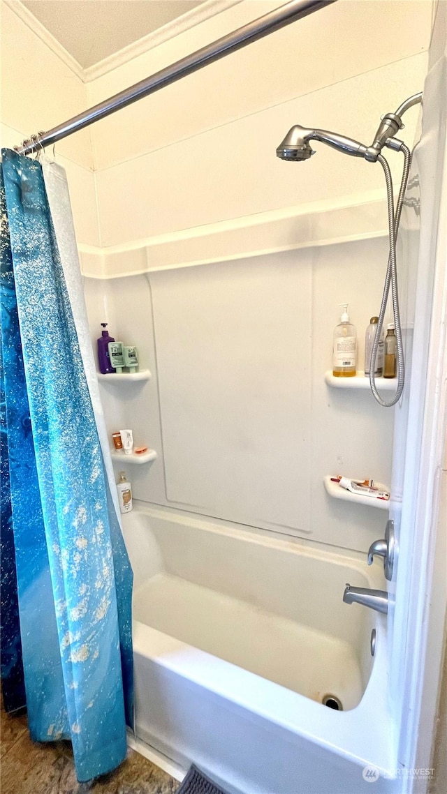 bathroom featuring shower / bath combination with curtain and ornamental molding