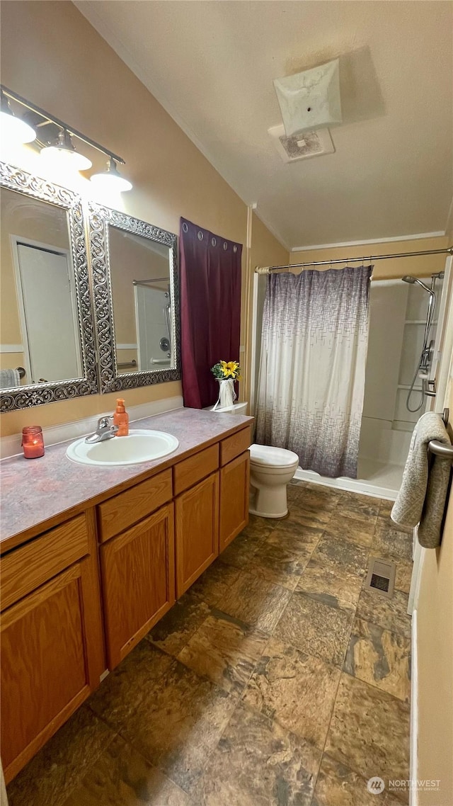 bathroom with a shower with curtain, vanity, lofted ceiling, and toilet