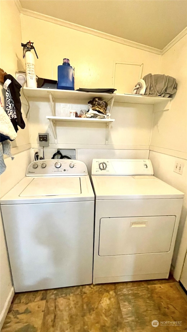 washroom featuring washer and clothes dryer and ornamental molding