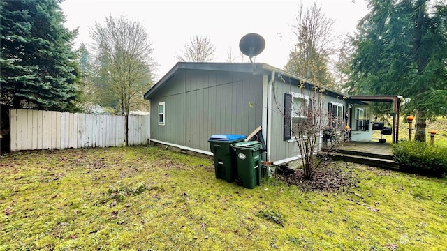 view of property exterior featuring a yard and a wooden deck