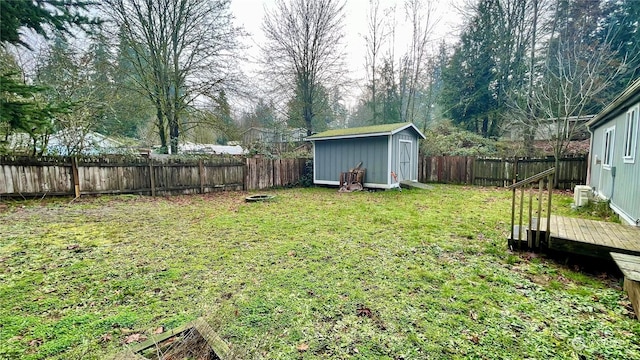 view of yard with a storage shed and a wooden deck