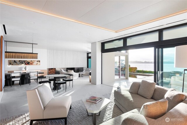 5505 Lake Washington Blvd NE Unit 1-D, Kirkland, WA 98033 - living room with floor to ceiling windows, a water view, and concrete floors