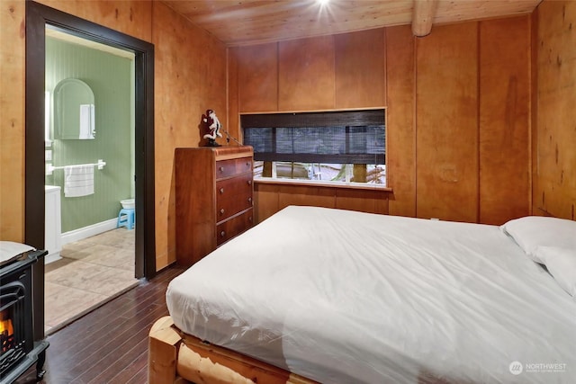 bedroom featuring dark hardwood / wood-style flooring, lofted ceiling with beams, wooden walls, and wood ceiling