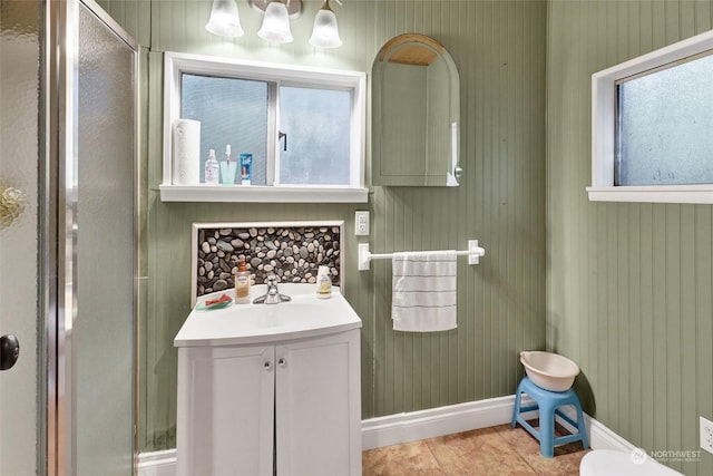 bathroom with a wealth of natural light, tile patterned flooring, and vanity