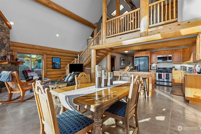 dining room featuring high vaulted ceiling, tile patterned floors, sink, log walls, and beamed ceiling