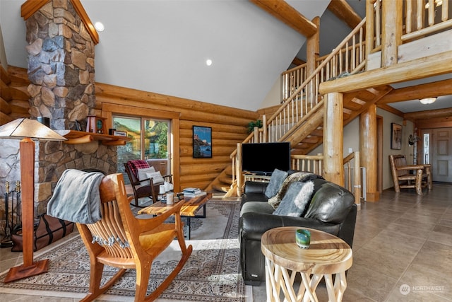 living room with beam ceiling, high vaulted ceiling, rustic walls, and a stone fireplace